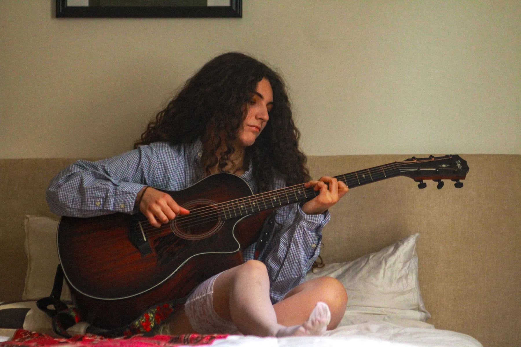 ATARAH seated with her acoustic guitar
